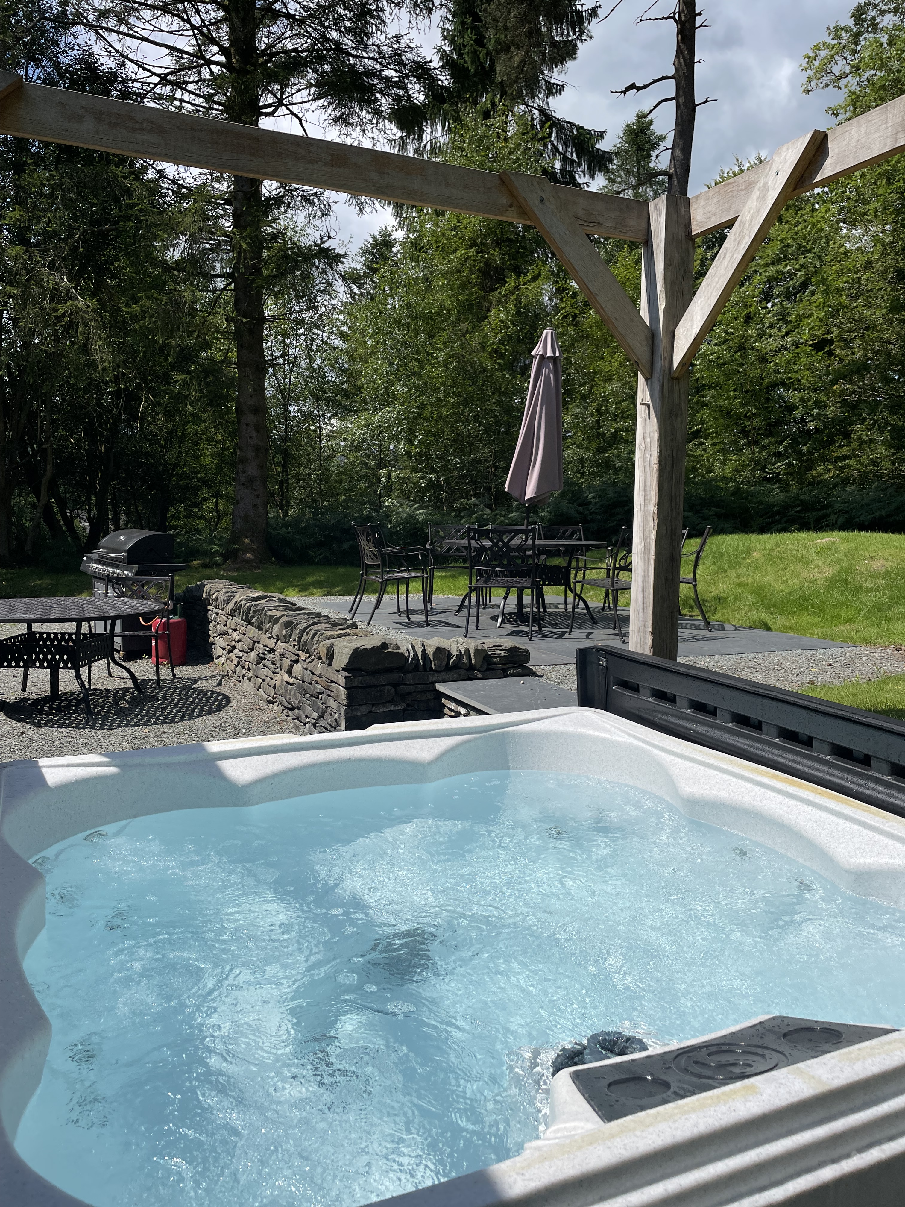 Greenhouse Hot Tub with BBQ in background
